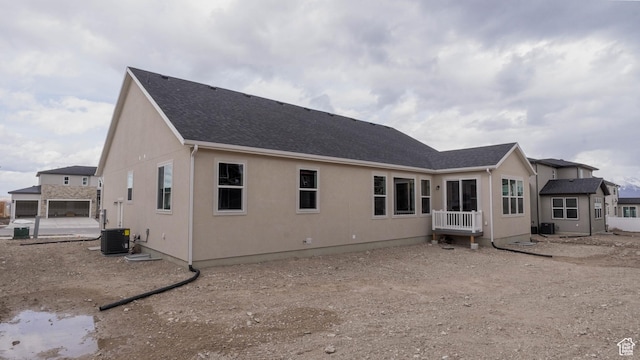 rear view of house with central air condition unit