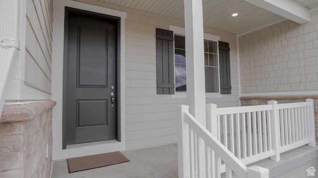 view of exterior entry with covered porch