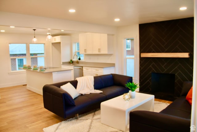 living room featuring sink and light wood-type flooring