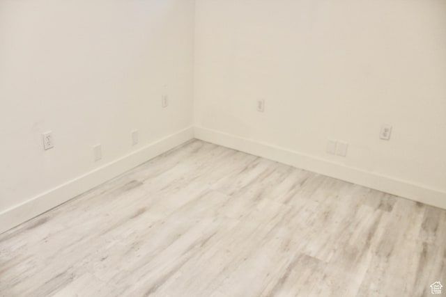 spare room featuring light hardwood / wood-style floors