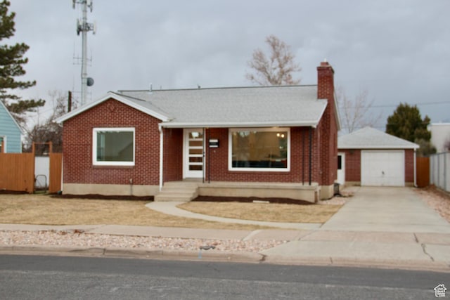 single story home featuring an outbuilding and a garage