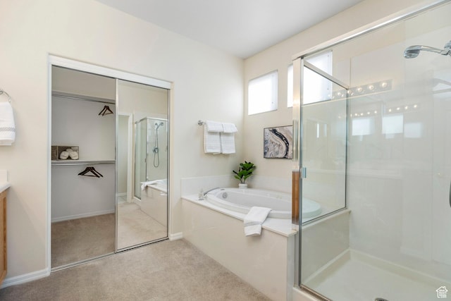 full bath featuring a stall shower, a bath, and vanity
