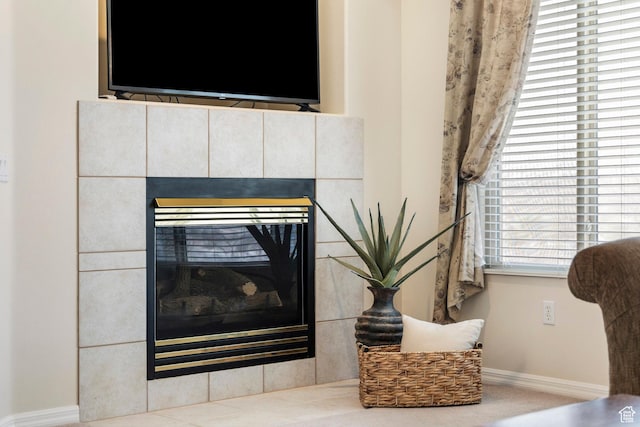 detailed view of baseboards and a tiled fireplace