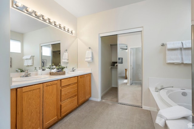 full bath with a garden tub, double vanity, baseboards, and carpet floors