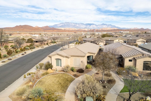 aerial view of residential area featuring mountains