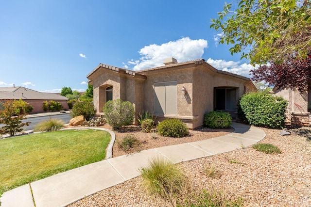 view of front of home with stucco siding and a front lawn