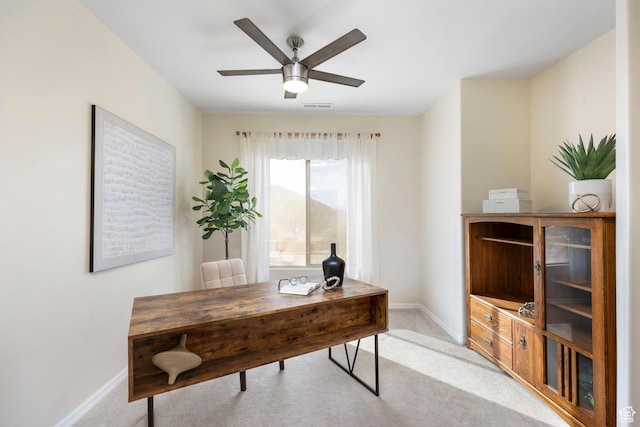 home office featuring baseboards, light colored carpet, and ceiling fan