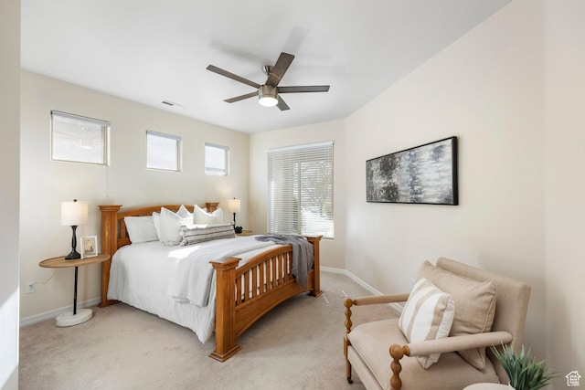 bedroom with light carpet, baseboards, and ceiling fan