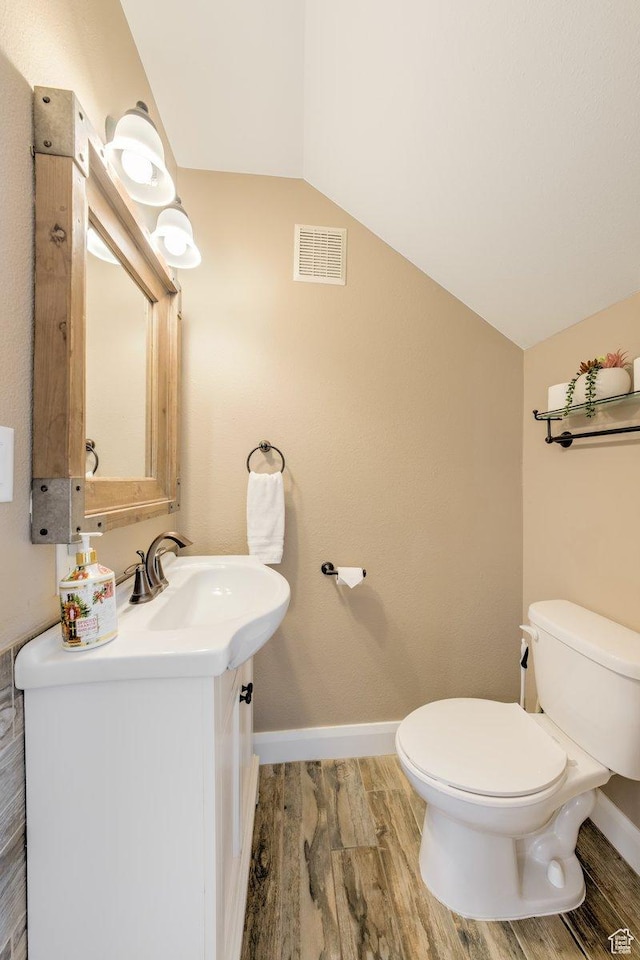 286 W Eagles Roost St Unit D-101, Brian Head, UT 84719 - bathroom featuring lofted ceiling, vanity, toilet, and wood-type flooring