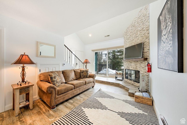 286 W Eagles Roost St Unit D-101, Brian Head, UT 84719 - living room with lofted ceiling, a fireplace, and light hardwood / wood-style floors