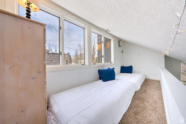 286 W Eagles Roost St Unit D-101, Brian Head, UT 84719 - carpeted bedroom featuring lofted ceiling and a textured ceiling