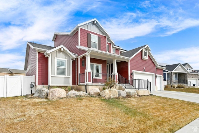 111 S 2300 W, Kaysville, UT 84037 - craftsman house featuring fence, board and batten siding, a porch, a front yard, and concrete driveway