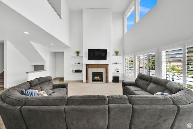 111 S 2300 W, Kaysville, UT 84037 - living area featuring baseboards, a towering ceiling, and a fireplace