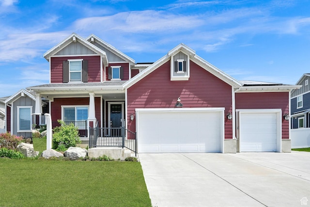 111 S 2300 W, Kaysville, UT 84037 - craftsman house with covered porch, board and batten siding, a garage, a front lawn, and concrete driveway