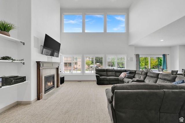 111 S 2300 W, Kaysville, UT 84037 - living area featuring carpet floors, baseboards, a fireplace, and a towering ceiling