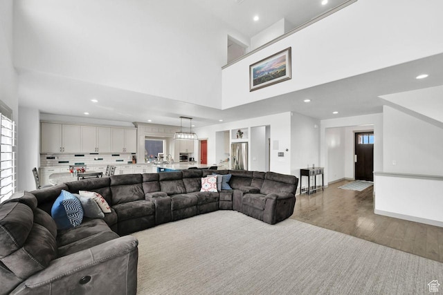 111 S 2300 W, Kaysville, UT 84037 - living area featuring recessed lighting, light wood-style flooring, a towering ceiling, and a healthy amount of sunlight