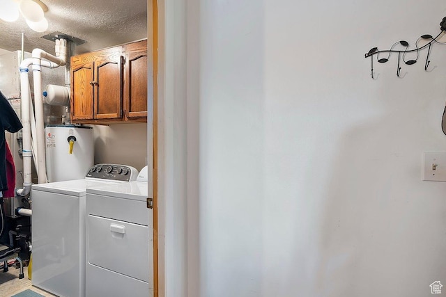 1127 W 4250 S, Riverdale, UT 84405 - clothes washing area with cabinet space, water heater, washer and clothes dryer, and a textured ceiling