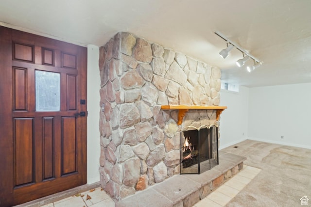 1078 Sumac Dr, Logan, UT 84321 - foyer entrance with light colored carpet, a stone fireplace, and rail lighting