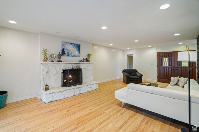 1078 Sumac Dr, Logan, UT 84321 - living room featuring a stone fireplace and light hardwood / wood-style flooring