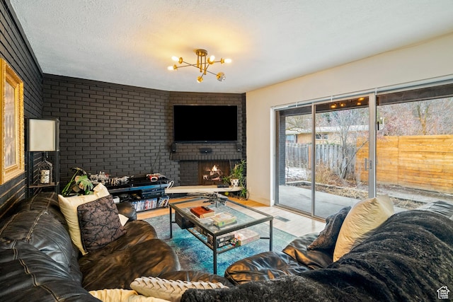 1078 Sumac Dr, Logan, UT 84321 - living room featuring a notable chandelier, hardwood / wood-style floors, a textured ceiling, and a fireplace