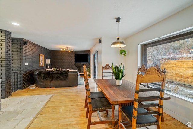 1078 Sumac Dr, Logan, UT 84321 - dining area featuring brick wall and light hardwood / wood-style flooring