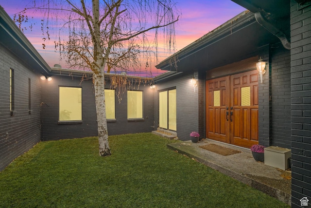 1078 Sumac Dr, Logan, UT 84321 - exterior entry at dusk with a yard