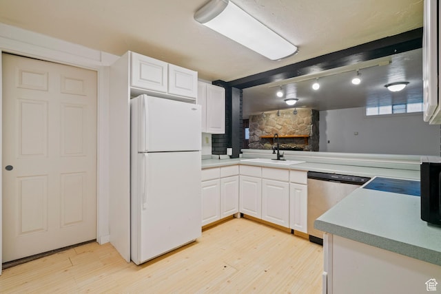 1078 Sumac Dr, Logan, UT 84321 - kitchen with white cabinetry, sink, stainless steel dishwasher, and white fridge