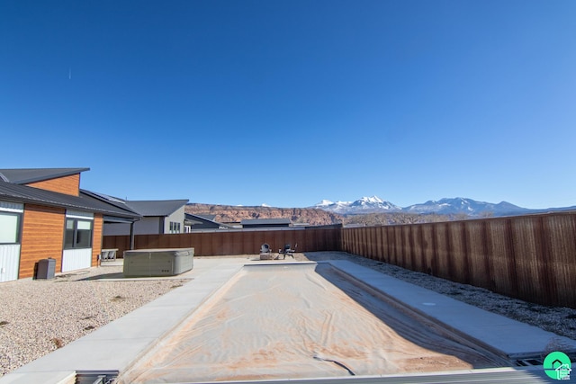 145 Crimson Cliffs Dr, Moab, UT 84532 - view of yard featuring a hot tub, a mountain view, and a patio area