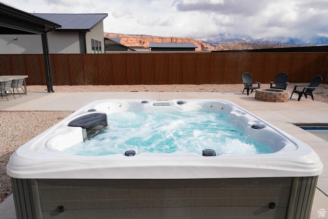 145 Crimson Cliffs Dr, Moab, UT 84532 - view of swimming pool featuring a mountain view, a fire pit, a hot tub, and a patio