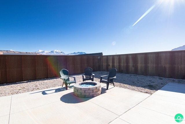 145 Crimson Cliffs Dr, Moab, UT 84532 - view of patio / terrace with a mountain view and an outdoor fire pit