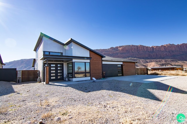 145 Crimson Cliffs Dr, Moab, UT 84532 - view of front of home with a mountain view and a garage