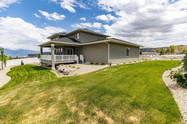 7288 W Hall Crossing Dr S, Herriman, UT 84096 - rear view of property with a mountain view and stucco siding
