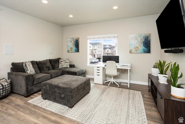 living area with recessed lighting, baseboards, and wood finished floors