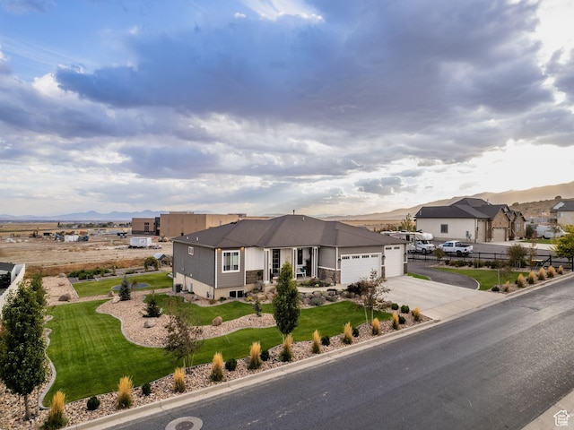 1352 E Abigail Ln, Eagle Mountain, UT 84005 - view of front of house with a garage, a mountain view, and a front lawn