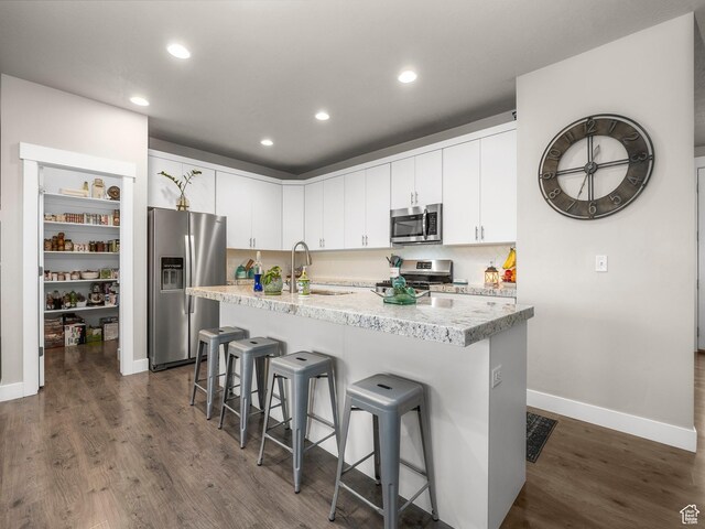 1352 E Abigail Ln, Eagle Mountain, UT 84005 - kitchen featuring sink, an island with sink, white cabinets, and appliances with stainless steel finishes