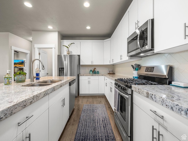 1352 E Abigail Ln, Eagle Mountain, UT 84005 - kitchen with tasteful backsplash, white cabinetry, sink, stainless steel appliances, and dark wood-type flooring