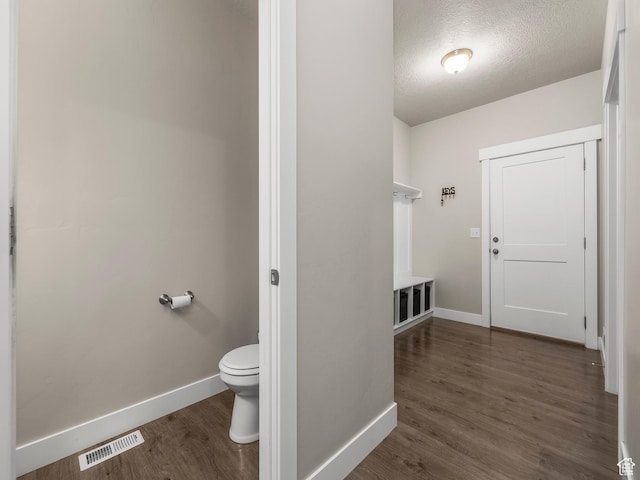 1352 E Abigail Ln, Eagle Mountain, UT 84005 - bathroom featuring wood-type flooring, toilet, and a textured ceiling