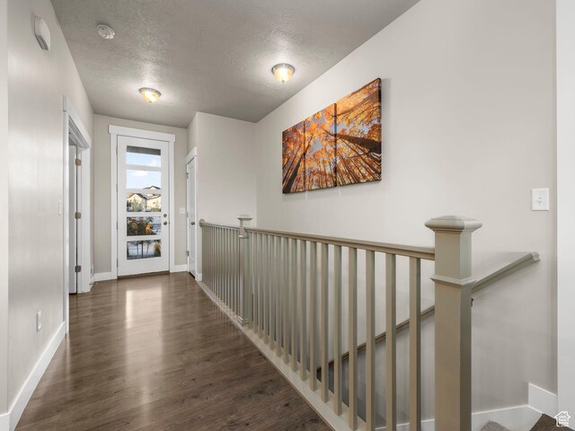 1352 E Abigail Ln, Eagle Mountain, UT 84005 - corridor with dark wood-type flooring and a textured ceiling