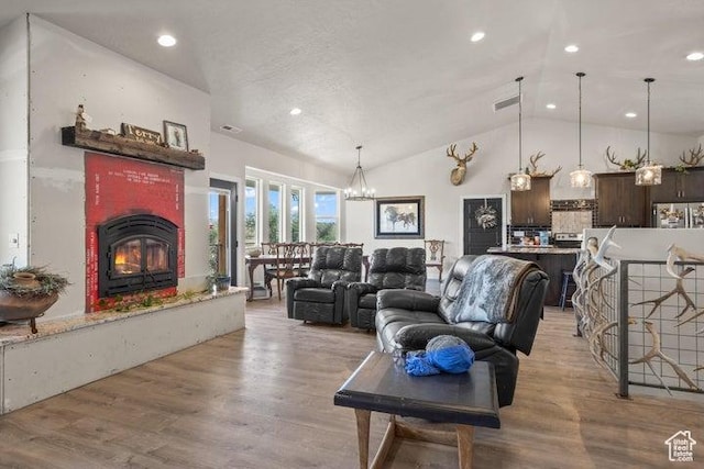 711 W Main St, Enterprise, UT 84725 - living room featuring a notable chandelier, high vaulted ceiling, and light wood-type flooring