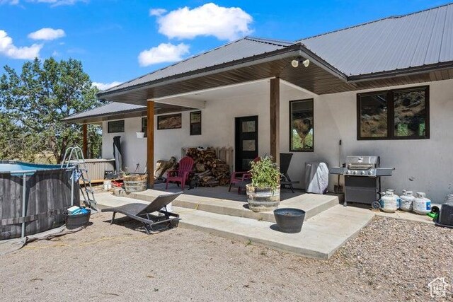 711 W Main St, Enterprise, UT 84725 - back of house with a patio and a pool with hot tub
