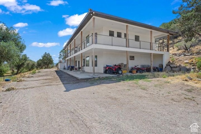 711 W Main St, Enterprise, UT 84725 - back of house featuring a balcony and a patio