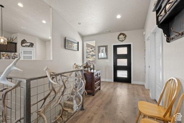 711 W Main St, Enterprise, UT 84725 - foyer with vaulted ceiling, hardwood / wood-style floors, and a textured ceiling