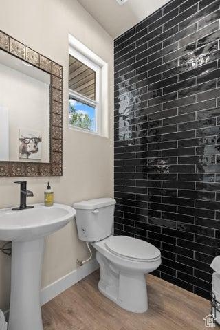 711 W Main St, Enterprise, UT 84725 - bathroom with wood-type flooring, sink, and toilet