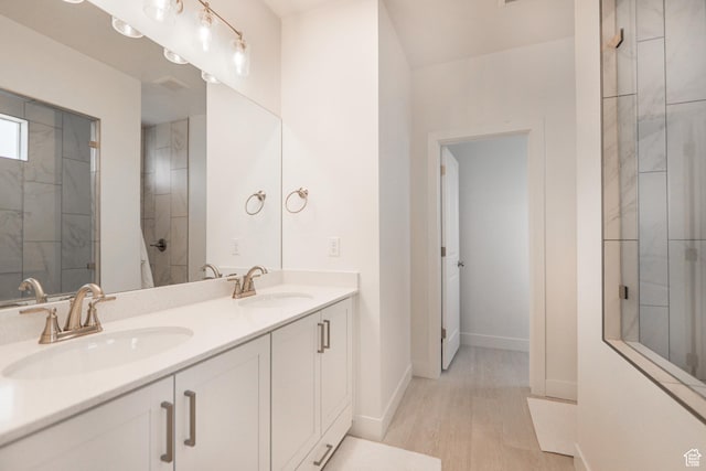 651 W Owen Dr, St George, UT 84790 - bathroom with vanity, a tile shower, and hardwood / wood-style floors