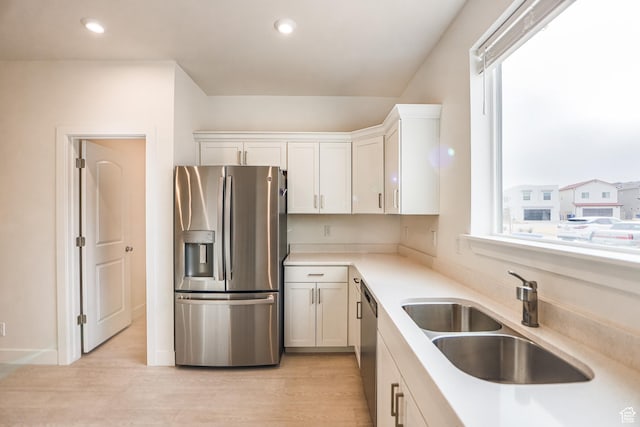 651 W Owen Dr, St George, UT 84790 - kitchen featuring appliances with stainless steel finishes, sink, white cabinetry, and light wood-type flooring