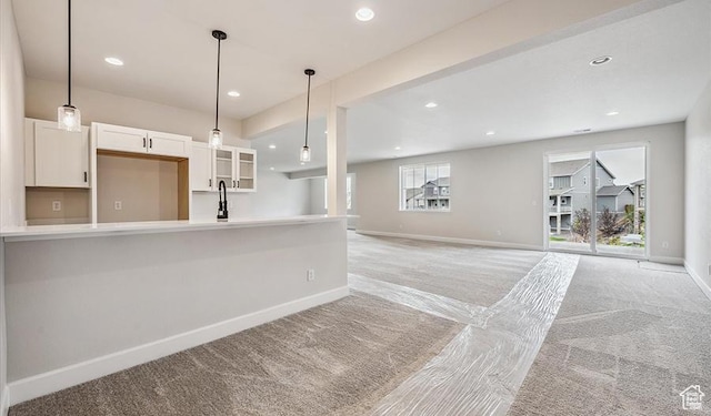 6187 W Wapiti Ridge Ln Unit 334, Herriman, UT 84096 - kitchen with sink, light carpet, white cabinets, and decorative light fixtures