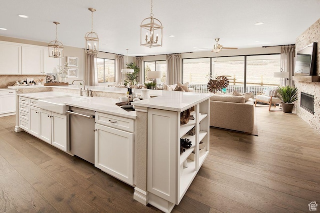 6187 W Wapiti Ridge Ln Unit 334, Herriman, UT 84096 - kitchen featuring pendant lighting, hardwood / wood-style floors, white cabinetry, and an island with sink