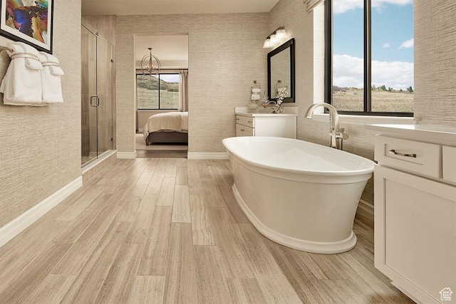 6187 W Wapiti Ridge Ln Unit 334, Herriman, UT 84096 - bathroom with vanity, hardwood / wood-style floors, and independent shower and bath