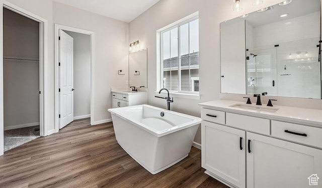 6187 W Wapiti Ridge Ln Unit 334, Herriman, UT 84096 - bathroom with hardwood / wood-style flooring, vanity, and independent shower and bath