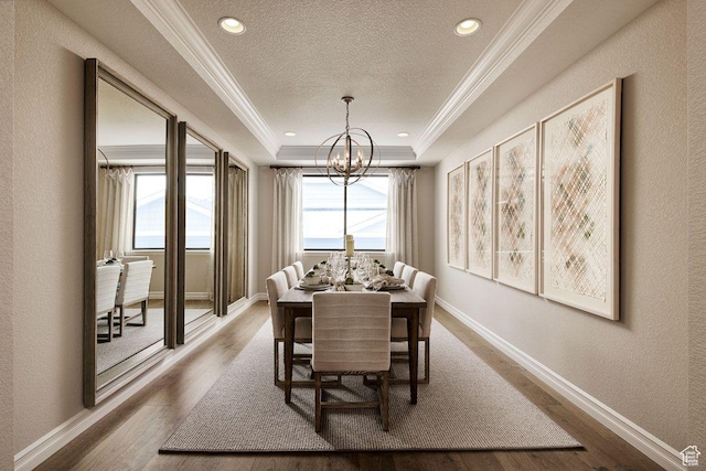 6187 W Wapiti Ridge Ln Unit 334, Herriman, UT 84096 - dining area featuring ornamental molding, hardwood / wood-style floors, a textured ceiling, and a tray ceiling